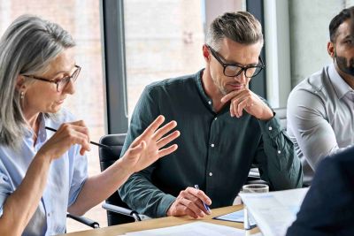 Business leaders discussing a plan round an office table.