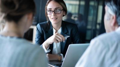 Young female lawyer talking with clients